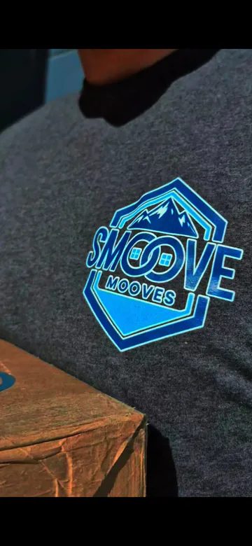 Close view of the Smoove Mooves mark printed on a crew shirt