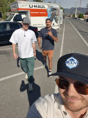 Three members of a moving crew together on move day in Salt Lake Valley